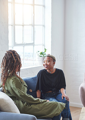 Buy stock photo two woman friends talking having conversation sitting on sofa at home