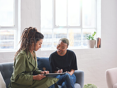 Buy stock photo African american woman writing notes with friend showing ideas on digital tablet computer students brainstorming