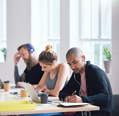 Buy stock photo College students sitting at table in class working on project