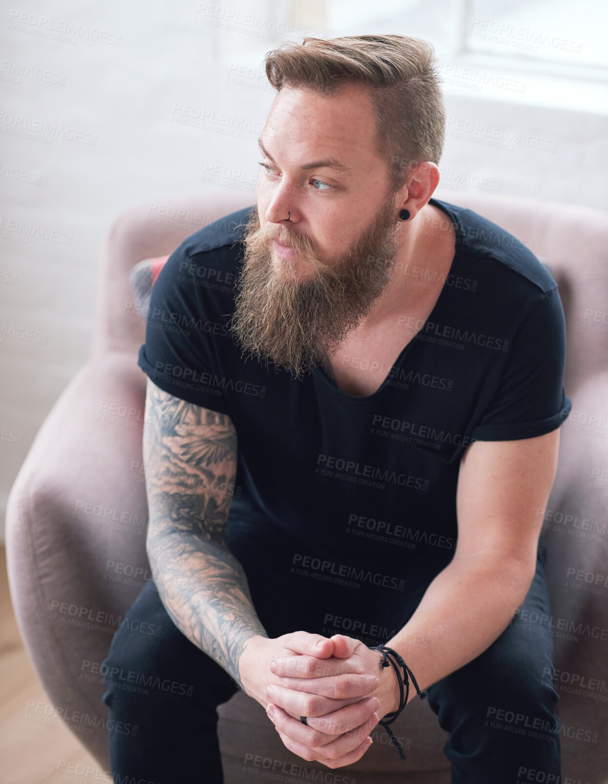 Buy stock photo Young hipster man with beard sitting looking out window contemplating