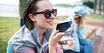 Beautiful woman using smartphone  on beachfront talking on mobile phone having conversation sharing summer vacation wearing sunglasses