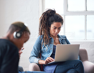 Buy stock photo Black woman working on laptop computer in internet cafe or young female student working on a project. African American people sitting, concentrating and working on web work on portable PC
