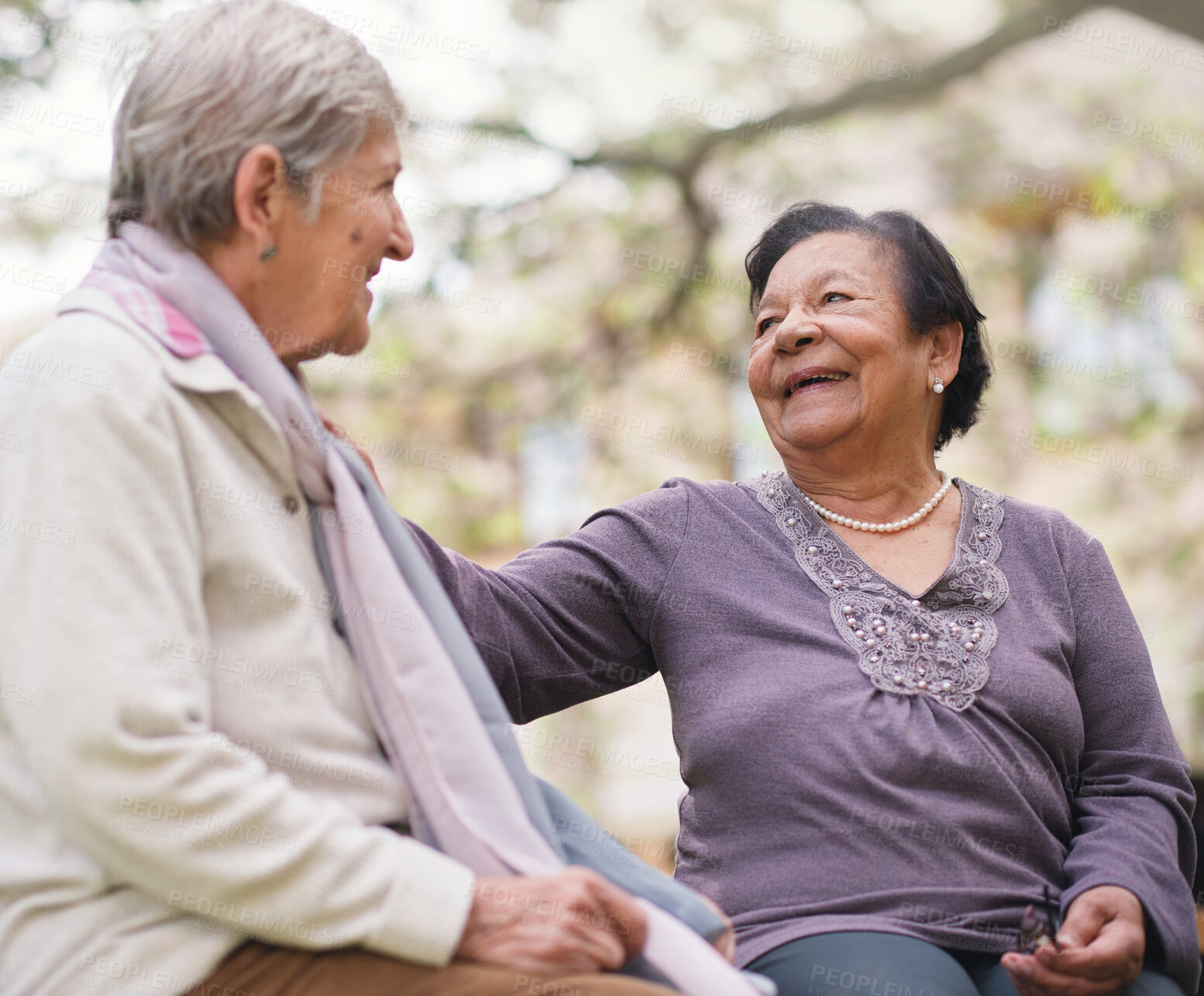 Buy stock photo Senior women, friends and conversation in outdoors, smile and bonding in retirement at park. Happy elderly people, love and connection or laughing for funny joke, communication and humor or speaking