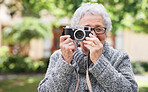 Funny old woman holding camera taking photo