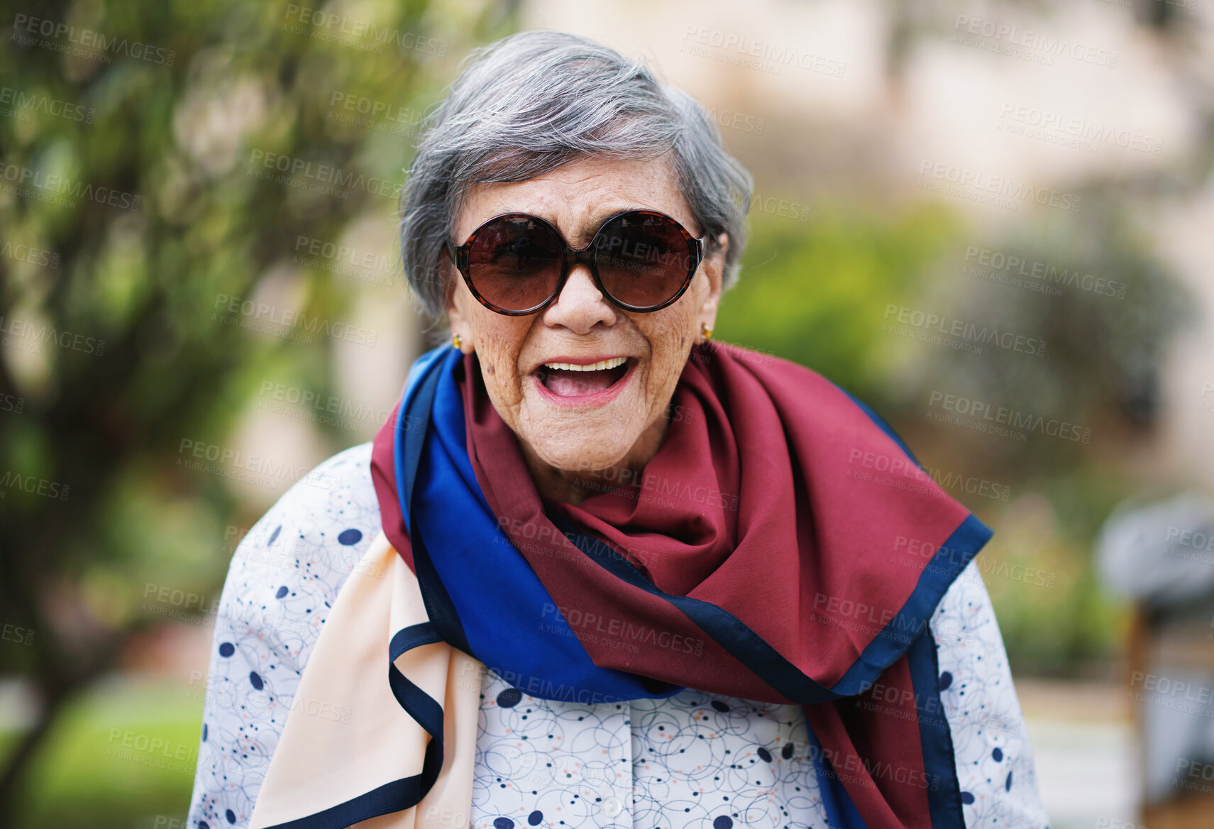 Buy stock photo Laughing, senior woman and garden or park with smile from walk, spring and nature. Elderly female person, happy and outdoor of retirement home or on vacation with travel in London with sunglasses