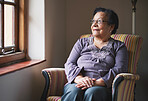 Happy elderly woman looking out window thinking of memories pensioner retirement lifestyle concept