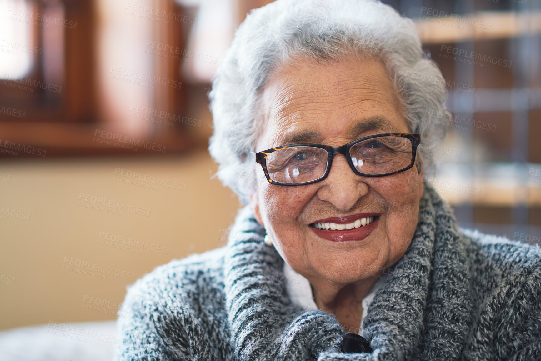 Buy stock photo Smile, glasses and portrait of senior woman sitting on sofa in the living room of retirement home. Happy, confident and headshot of elderly female person from Colombia with positive attitude at house