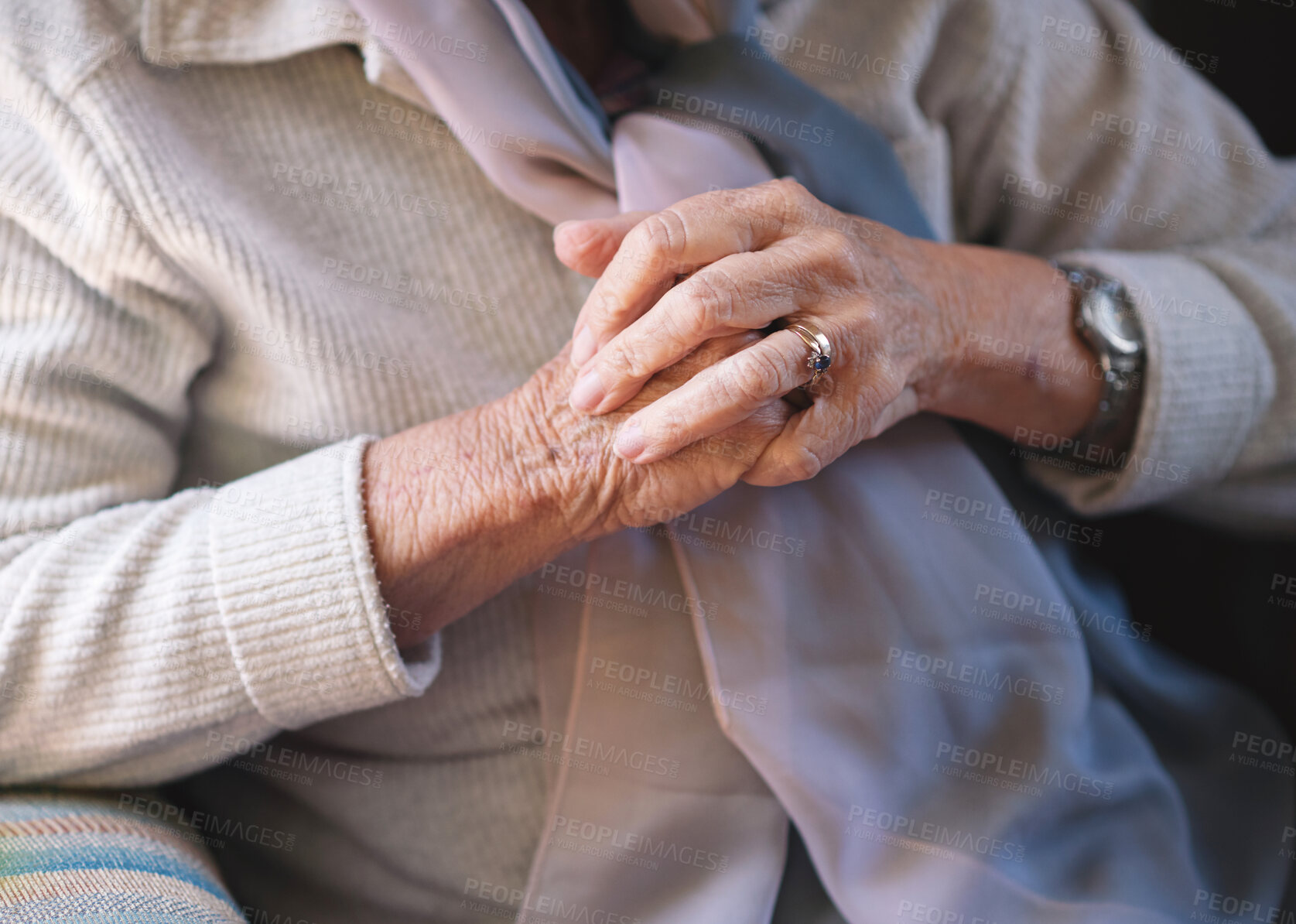 Buy stock photo Closeup, hands together and elderly woman with retirement, relax in a living room and peaceful on a weekend break. Pensioner, old person and senior lady with lonely feeling, home and calm on a couch