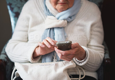 Buy stock photo Senior woman, hands and smartphone for mobile app, armchair and online conversation at home. Elderly person, social media and typing on technology for communication, connection and website to relax