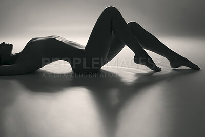 Buy stock photo A young naked woman lying on the ground