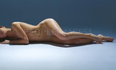 Buy stock photo Shot of a beautiful nude woman posing on her side