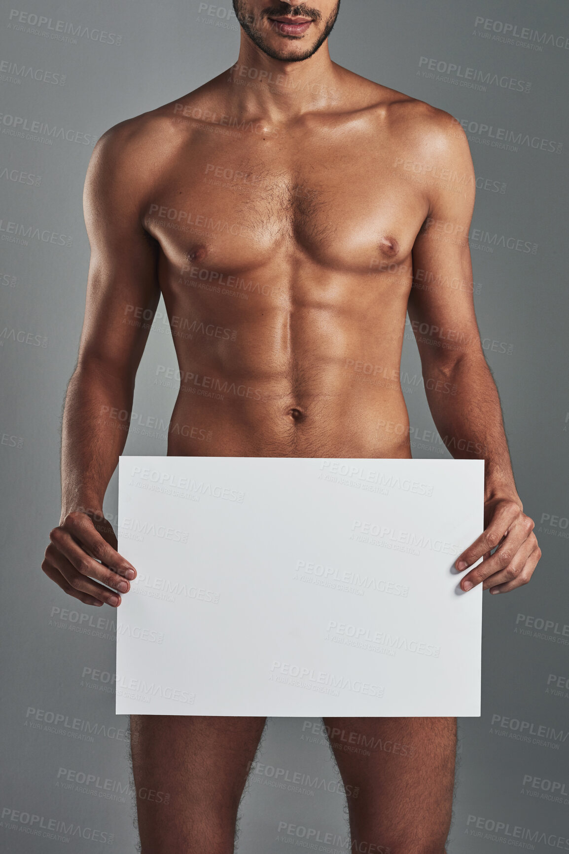 Buy stock photo Studio shot of a handsome and muscular young man holding a blank sign against a grey background