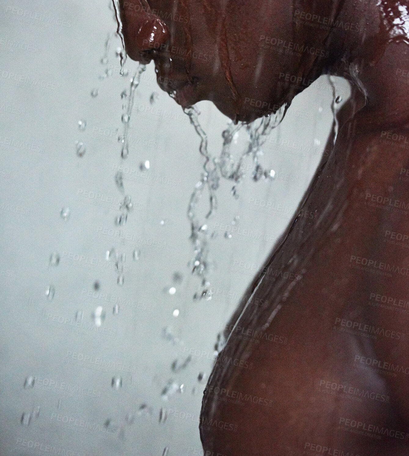 Buy stock photo Cropped shot of a handsome young man taking a shower at home
