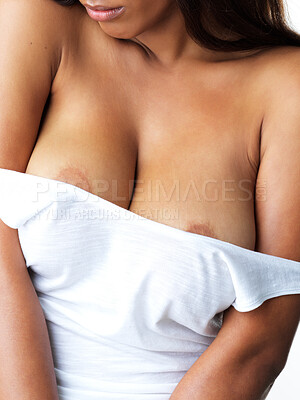 Buy stock photo Studio shot of a sexy young woman looking down while  dropping her tank top against a grey background