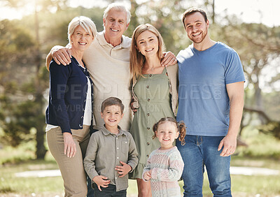Buy stock photo Portrait of a smiling multi generation caucasian family standing close together outdoors. Happy adorable sibling brother and sister bonding with their mother, father, grandfather and grandmother at a park