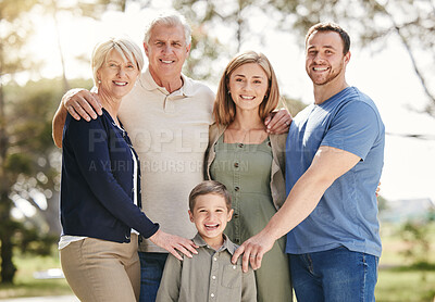 Buy stock photo Portrait of a smiling multi generation caucasian family standing close together outdoors. Adorable little boy bonding with his mother, father, grandfather and grandmother at a park