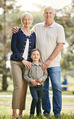 Buy stock photo Portrait of loving caucasian grandparents enjoying time with grandson in nature. Smiling little boy bonding with grandmother and grandfather. Happy seniors and child standing together outdoors