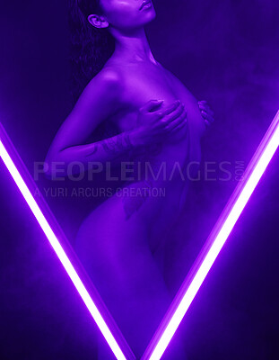 Buy stock photo Nude woman posing in studio isolated on black behind two purple neon lights. Sexy naked mixed race woman posing seductively between two beams of light in the shape of a V. Copyspace near the bottom