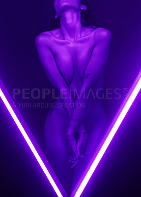 Buy stock photo Nude mixed race woman with tattoos posing seductively in a dark studio with two beams of purple neon lights. Sexy hot naked model flaunting sensual slim toned body in creative and artistic light