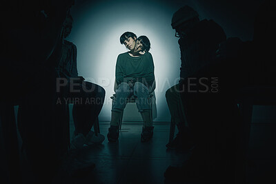 Buy stock photo One mixed race female suffering mental illness in asylum. Hispanic schizophrenic  woman experiencing a breakdown while being surrounded by people on a stage theatre performance