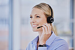 Young caucasian female call centre agent talking on headset while working in an office. Confident and happy businesswoman consulting and operating a helpdesk for customer sales and service support