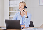 Young business woman working in modern office, making phone call while sitting in front of her laptop. Female entrepreneur talking to potential client on mobile phone,