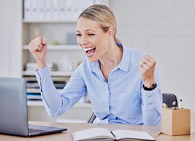 Cheerful young caucasian business woman celebrating her success. Excited female entrepreneur cheering with joy and making winning gesture while looking at laptop reading good news