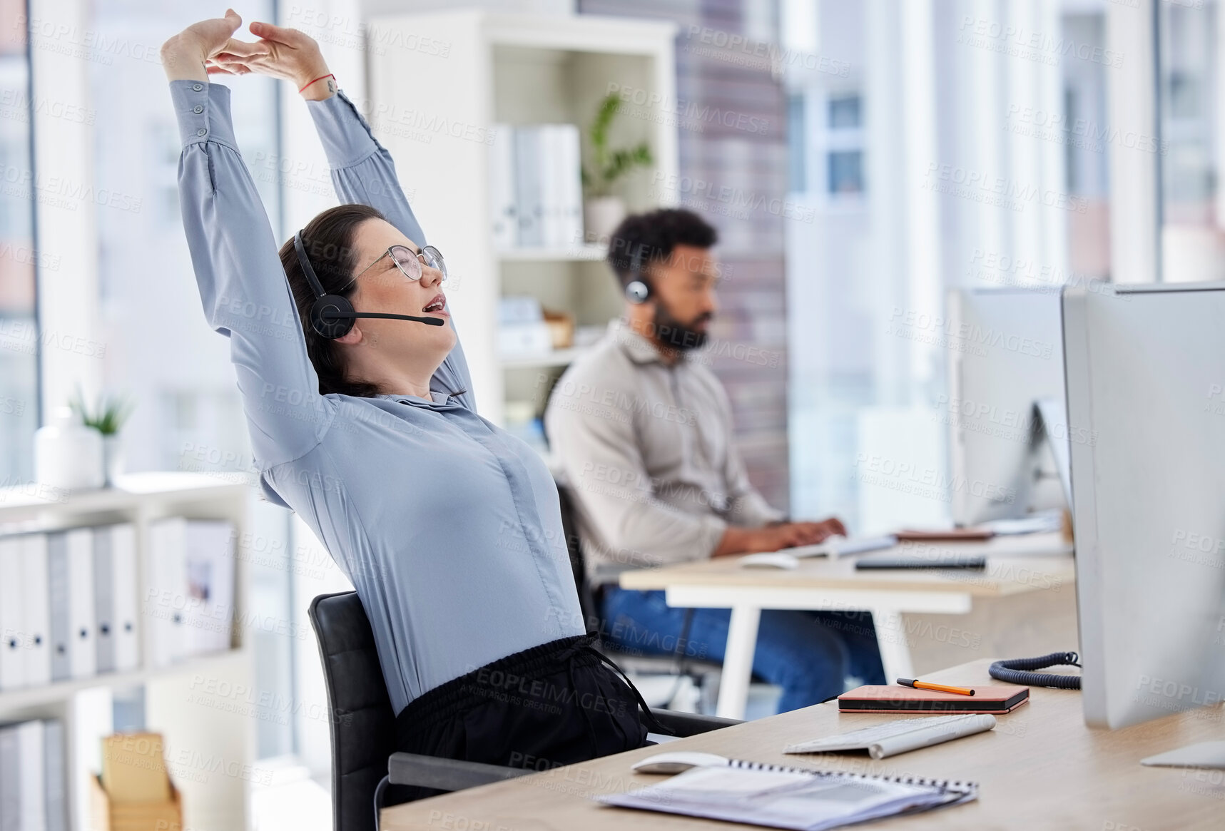 Buy stock photo Customer service, woman with headset and stretching her arms at her desk with a computer of modern workplace. Online communication, telemarketing and female call center agent stretch for fatigue 