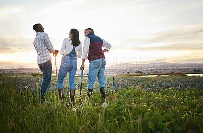 Buy stock photo Young farmers standing on a field with rakes, enjoying their break. Friends having fun on a farm. Men and woman getting ready to harvest fresh cabbages