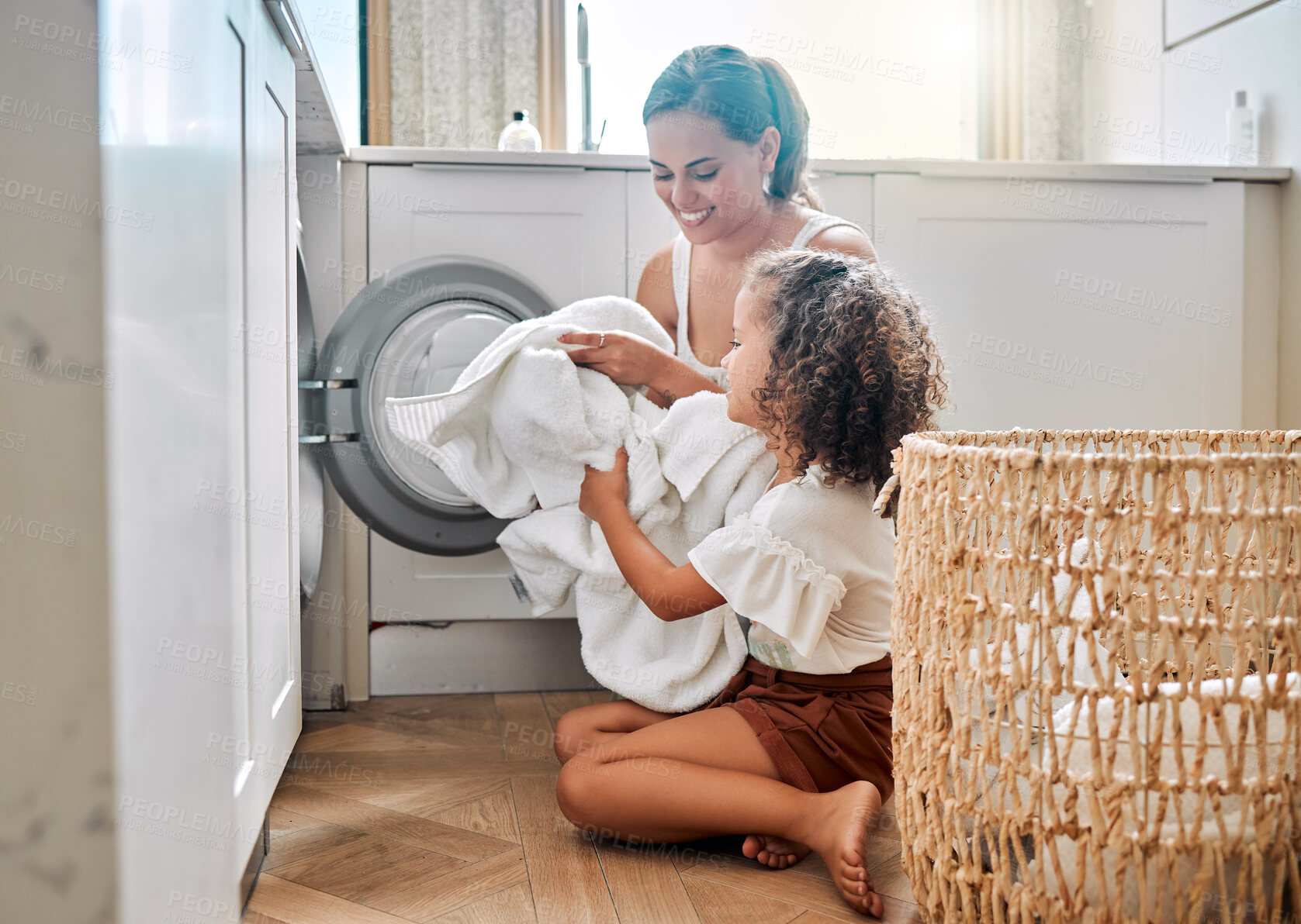 Buy stock photo Help, laundry and washing machine with mother and daughter for cleaning, learning and cleaner. Housekeeping, teamwork and basket with woman and young girl in family home for teaching and clothes