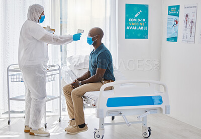 Buy stock photo Medical doctor using thermometer to scan the temperature of a patient. African American patients having their temperature scanned. Doctor checking a patient temperature for covid symptoms