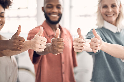 Buy stock photo Group of businesspeople showing a thumbs up together in an office at work. Content business professionals making a hand gesture showing support and agreement. Colleagues showing that they are pleased and happy