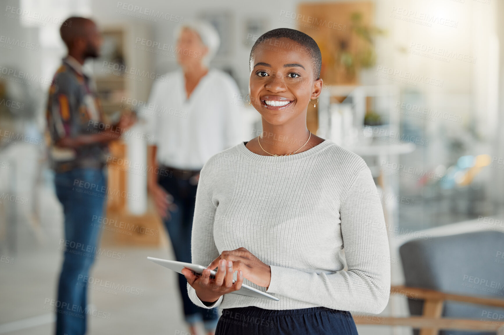 Buy stock photo Portrait of a happy african american businesswoman holding and using a digital tablet at work. Black female businessperson working on a digital tablet at work. Black woman using social media and browsing online