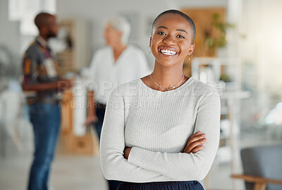 Portrait of a happy African american businesswoman standing with her arms crossed at work. One confident black female manager standing in an office at work. One content expert business professional at work