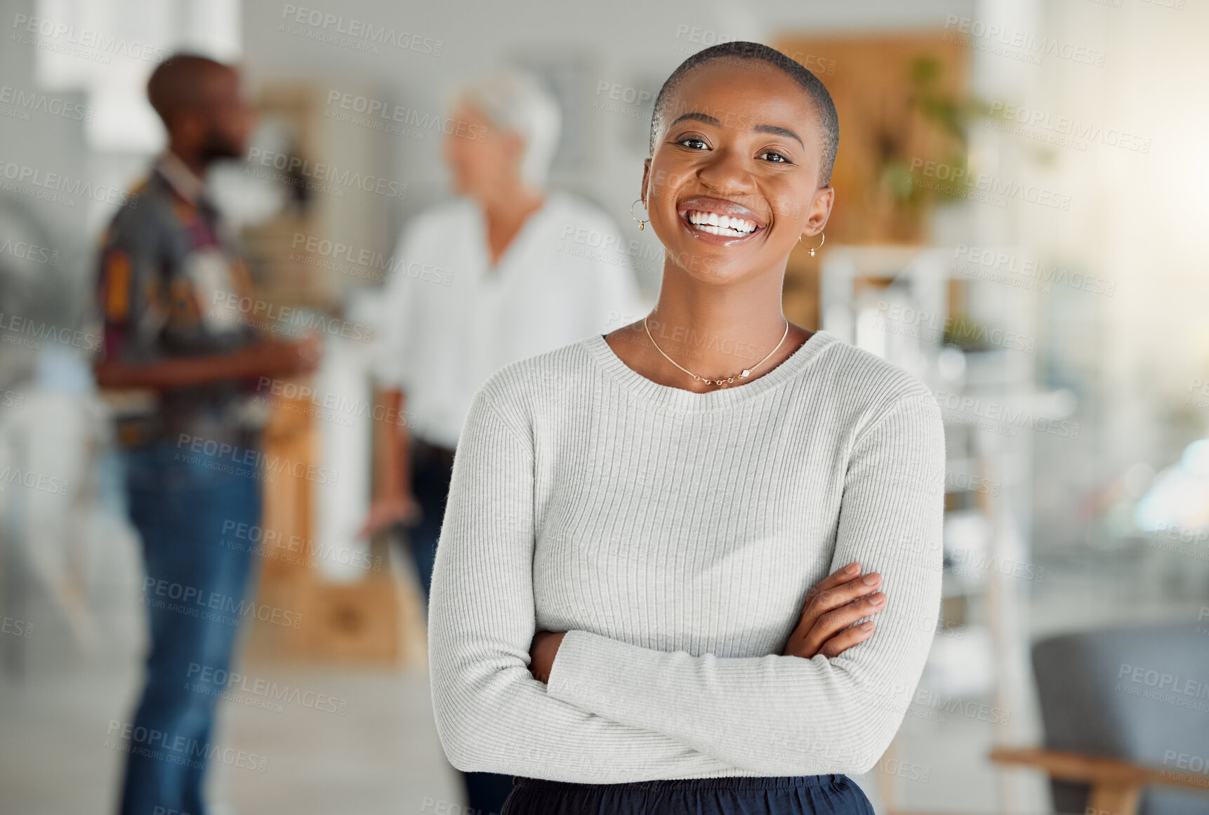 Buy stock photo Portrait of a happy African american businesswoman standing with her arms crossed at work. One confident black female manager standing in an office at work. One content expert business professional at work