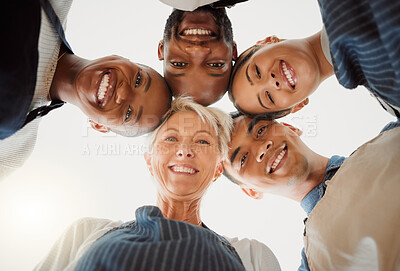 Buy stock photo Low portrait of a group of five cheerful diverse clothing designers standing together in an office at work. Happy tailors standing at work. Colleagues huddling together in support and motivation
