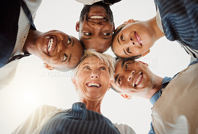 Buy stock photo Group of five cheerful diverse clothing designers standing together in an office at work. Happy tailors standing at work. Colleagues huddling together in support and motivation