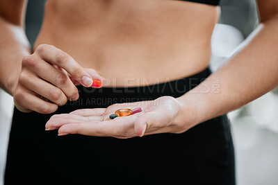 Closeup of unknown trainer alone in gym picking from variety of steroid pills. Caucasian coach with hormone enhancing drugs for workout in exercise health club. Bodybuilder woman in fitness centre