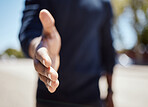 Closeup of an unknown businessman holding his hand out for a handshake in a outside in the city