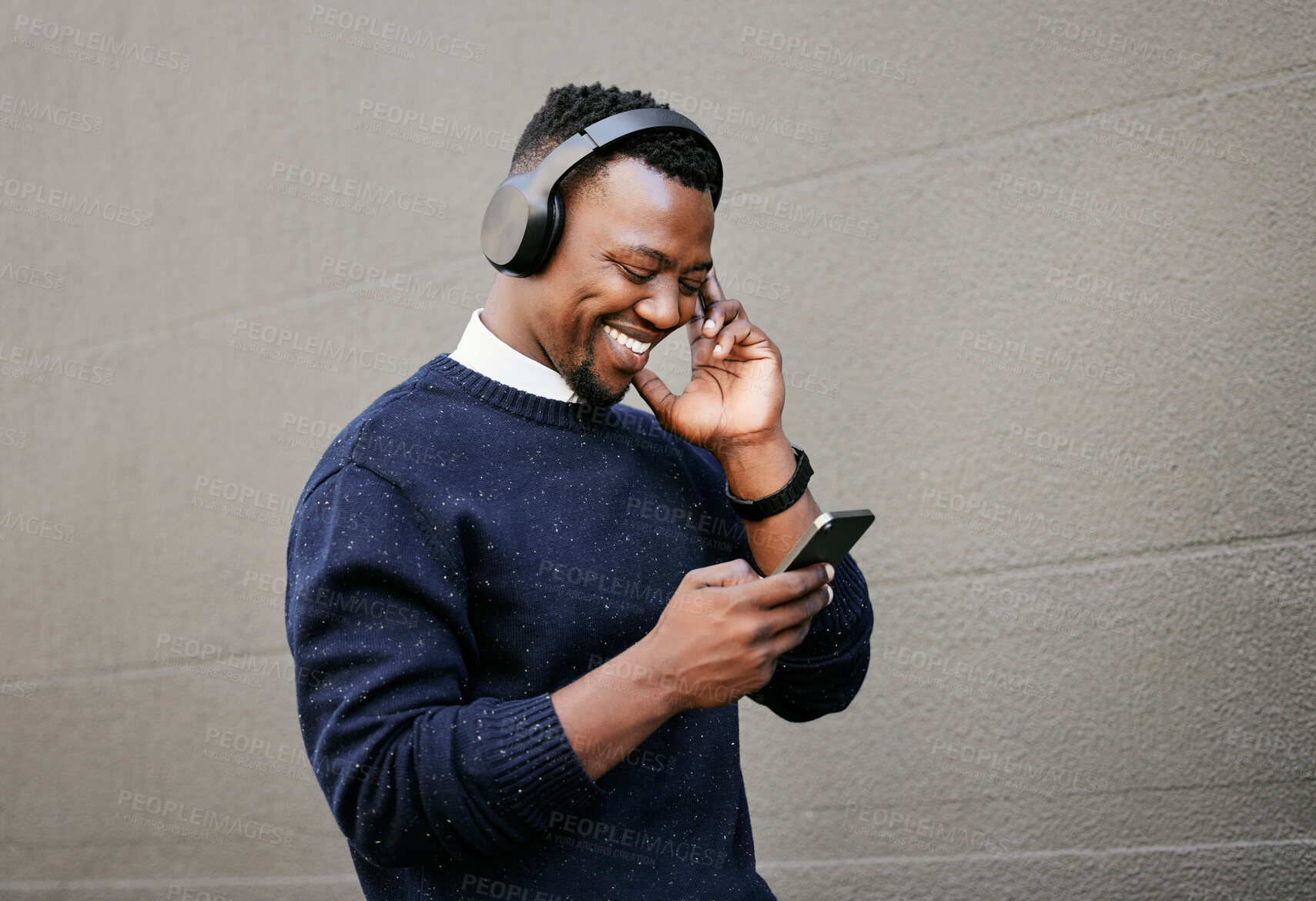 Buy stock photo Outdoor, black man and smile on smartphone with headphones for streaming music Uganda. Male person, employee and happy with browsing internet for social media, website and podcast for entertainment