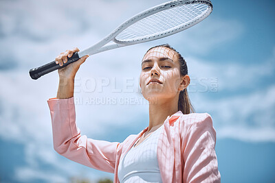 Buy stock photo Close up of beautiful hispanic female tennis player holding tennis racket over her head while standing against a blue sky. Sportswoman looking serious and ready for a game of tennis