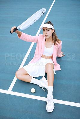 Buy stock photo Trendy young tennis player wearing a pink jacket while sitting on a tennis court. Young hispanic sportswoman sitting with a tennis racket and ball on a sunny day