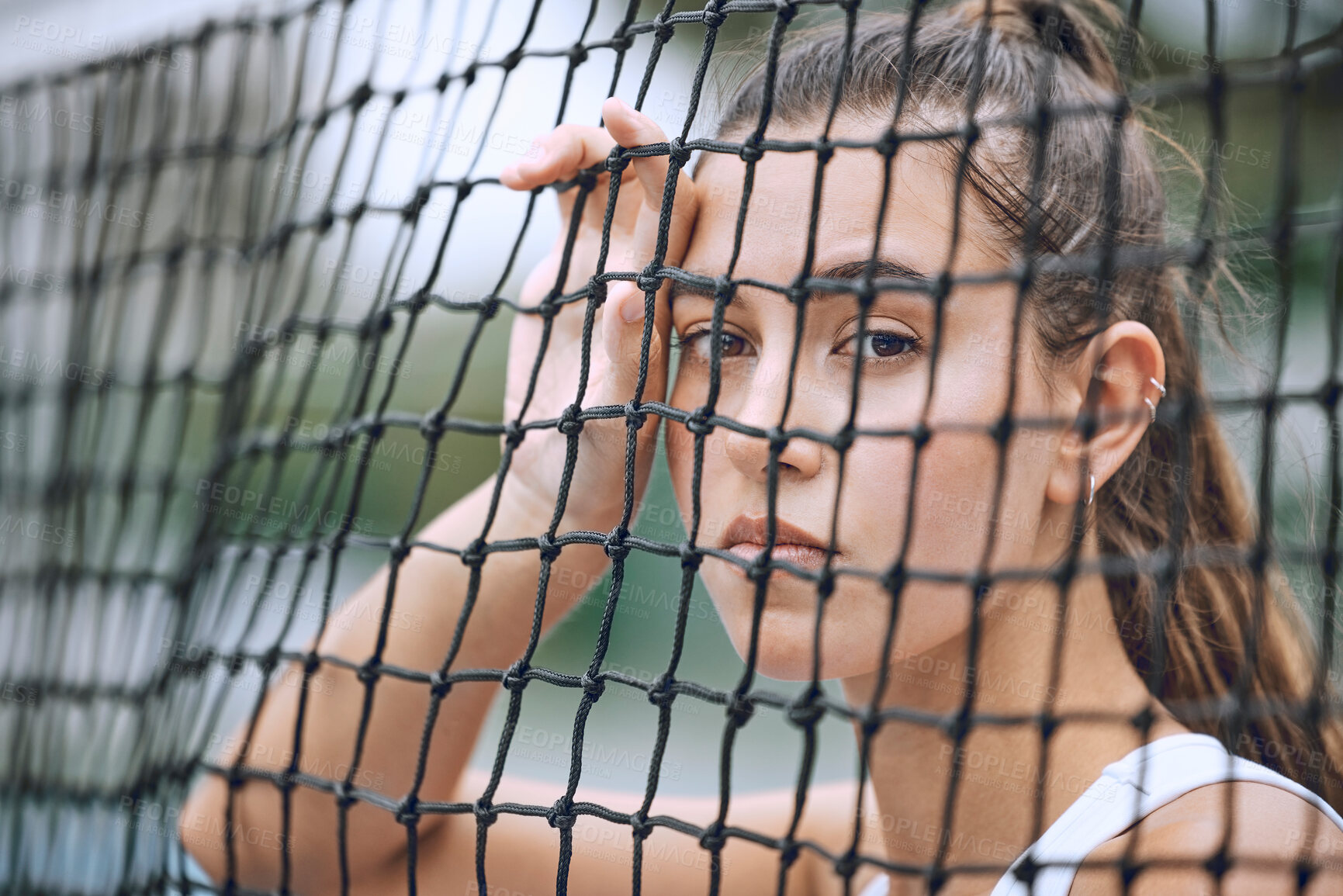 Buy stock photo Close up of a female athlete leaning against a tennis net. Young hispanic tennis player posing on a tennis court