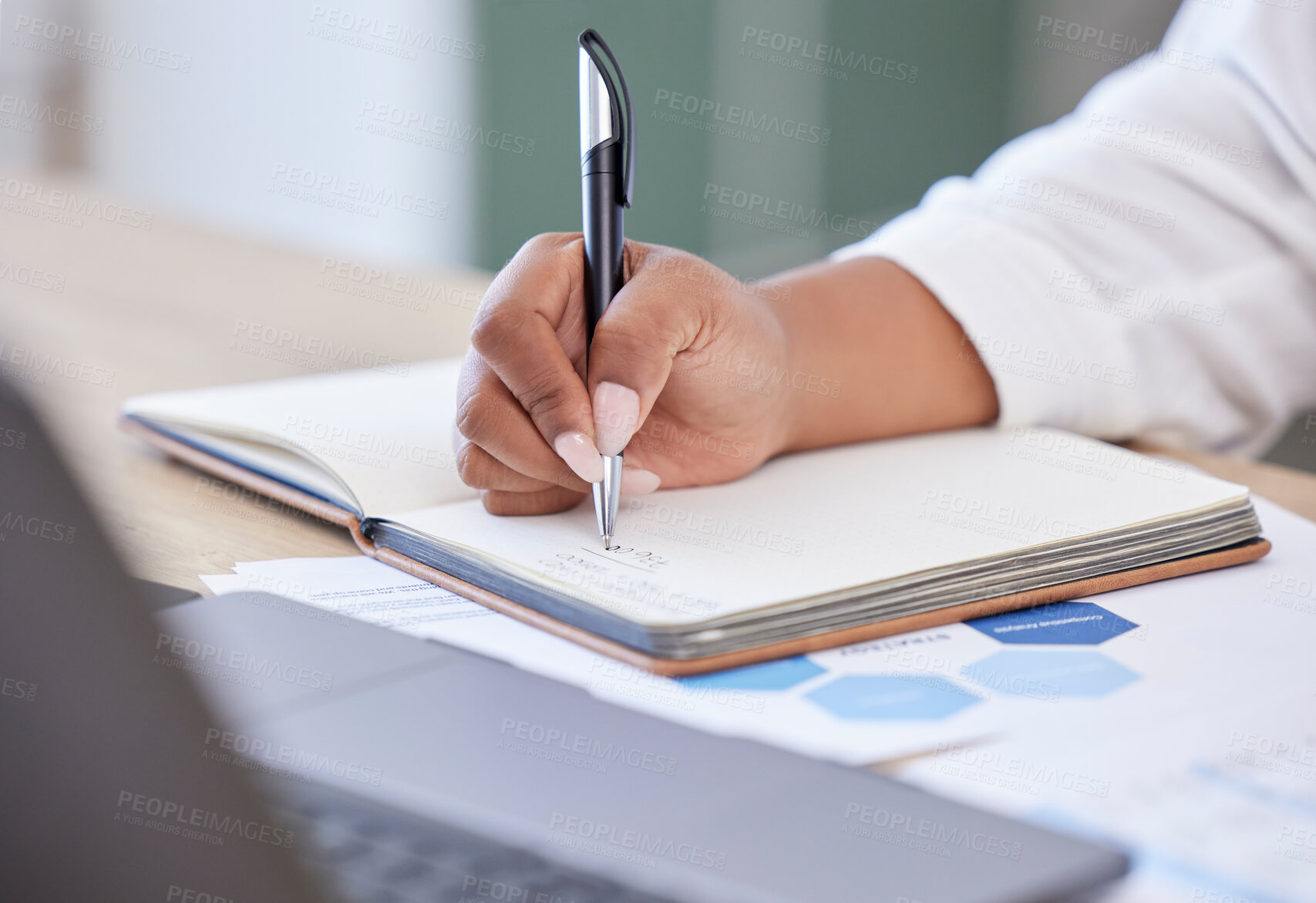 Buy stock photo Closeup, businesswoman writing in a notebook and at her desk in a modern office workplace. Planning or schedule, brainstorming idea or startup and female person write notes in a book for strategy