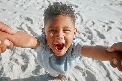 Buy stock photo Excited little mixed race boy having fun while his father spins him around by the arms. Energetic son playing and spending time with parent while on holiday
