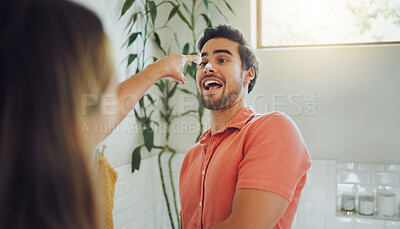 Buy stock photo Close up of happy young caucasian couple having fun in the bathroom. Boyfriend pulling away as girlfriend playfully tries to smear foam on his nose while washing her hands
