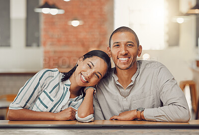 Portrait of happy loving mixed race couple enjoying time together on first date. Young woman and man on a coffee date in a cafe during the day