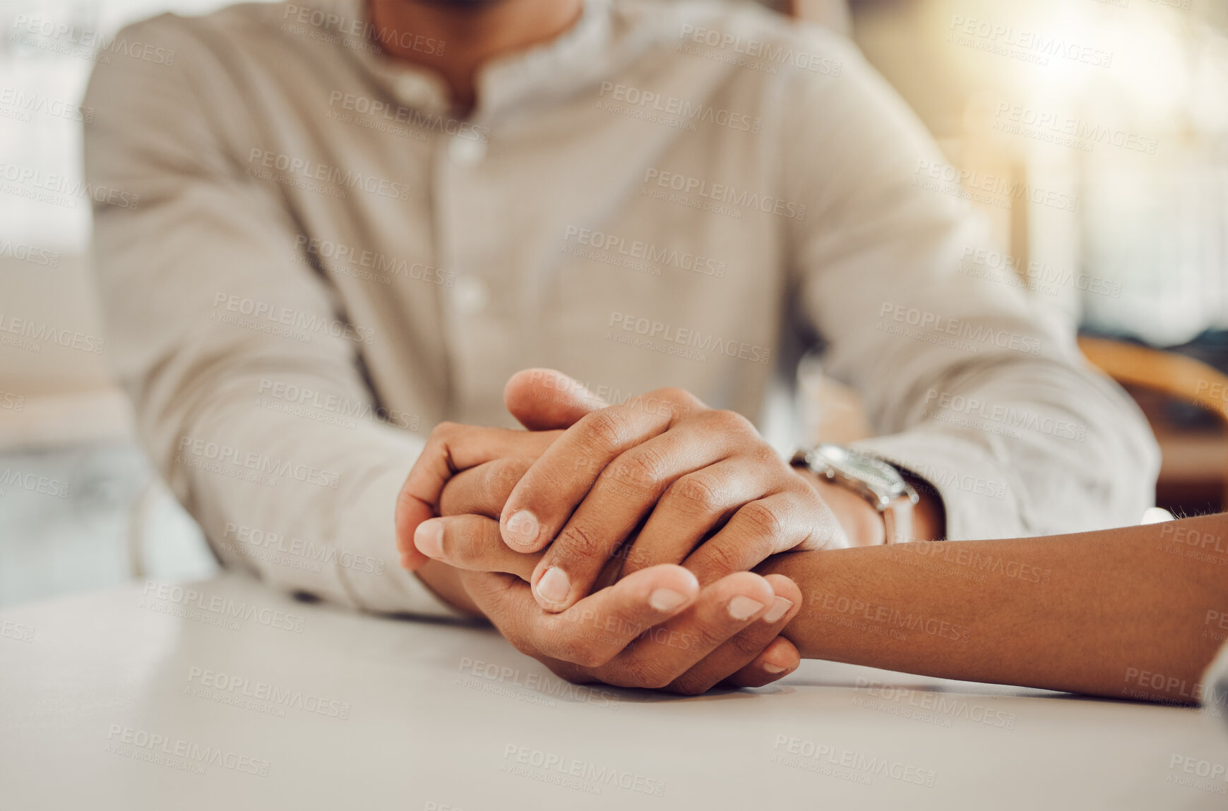 Buy stock photo Close up of young man and woman holding hands at wooden table, from above. Loving couple expressing empathy, understanding and trust in their relationship