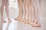 Closeup woman dance instructor teaching a ballet class to a group of a children in her studio. Ballerina teacher working with girl students, preparing for their recital, performance or upcoming show