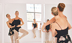 Young woman dance instructor teaching a ballet class to a group of a children in her studio. Ballerina teacher working with girl students, preparing for their recital, performance or upcoming show